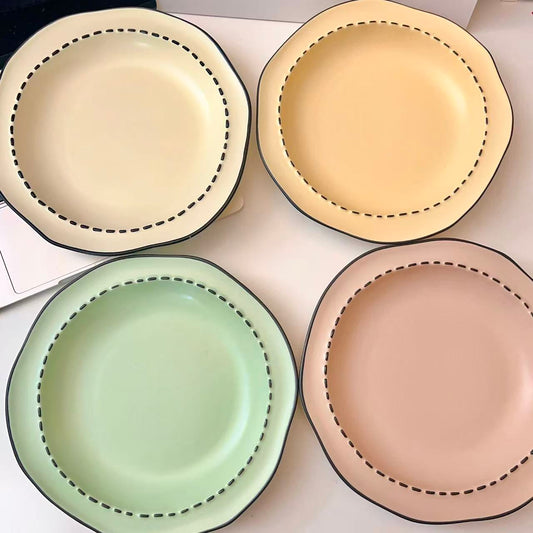 Four macaron color ceramic plates: off-white, yellow, matcha green, pink with manga style black rim