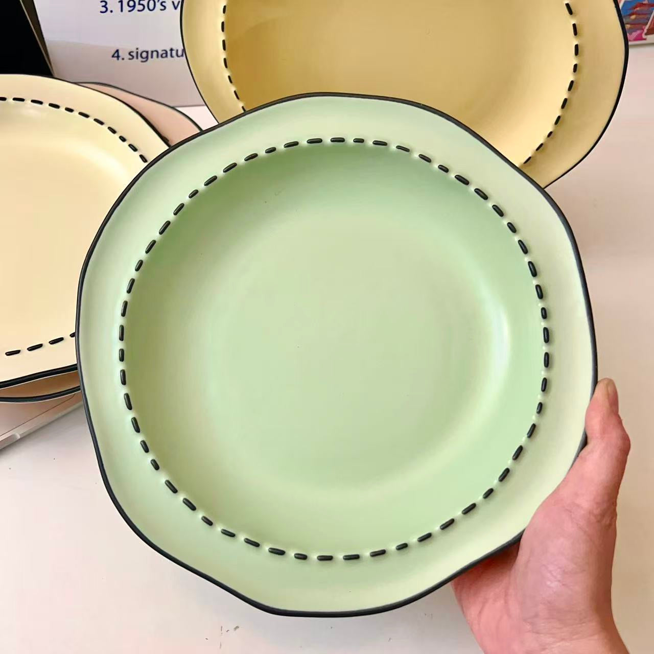 Four macaron color ceramic plates: off-white, yellow, matcha green, pink with manga style black rim