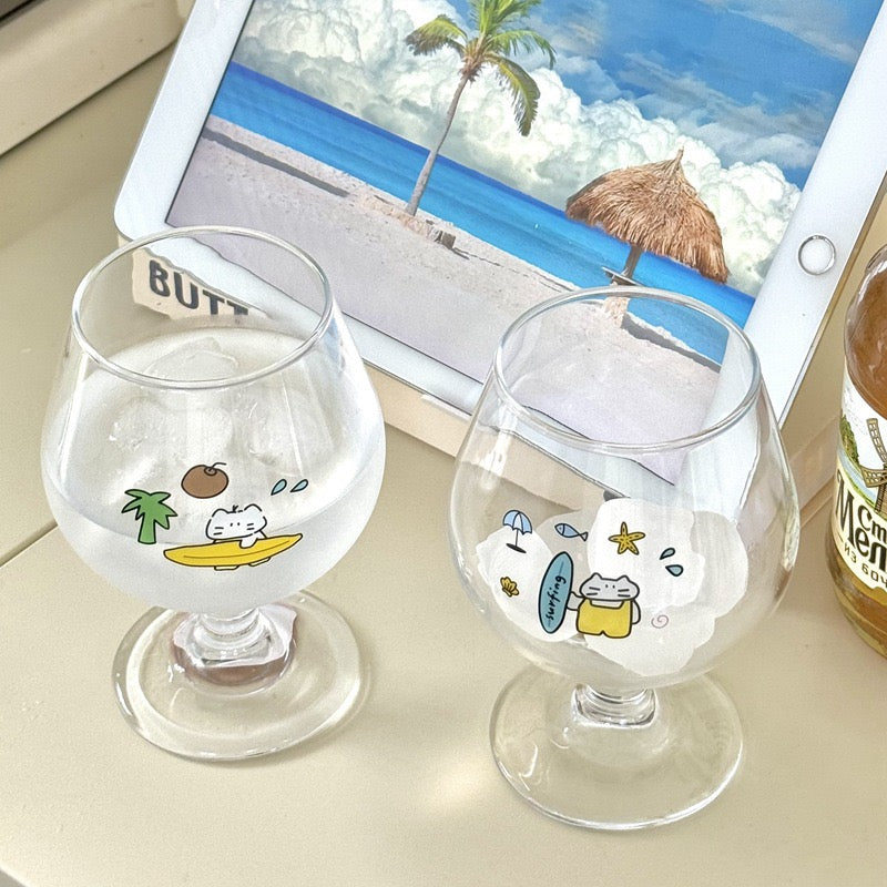 Surfing cat footed glass cups showing blue and yellow surfboard designs, 300ML