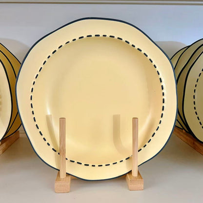 Four macaron color ceramic plates: off-white, yellow, matcha green, pink with manga style black rim