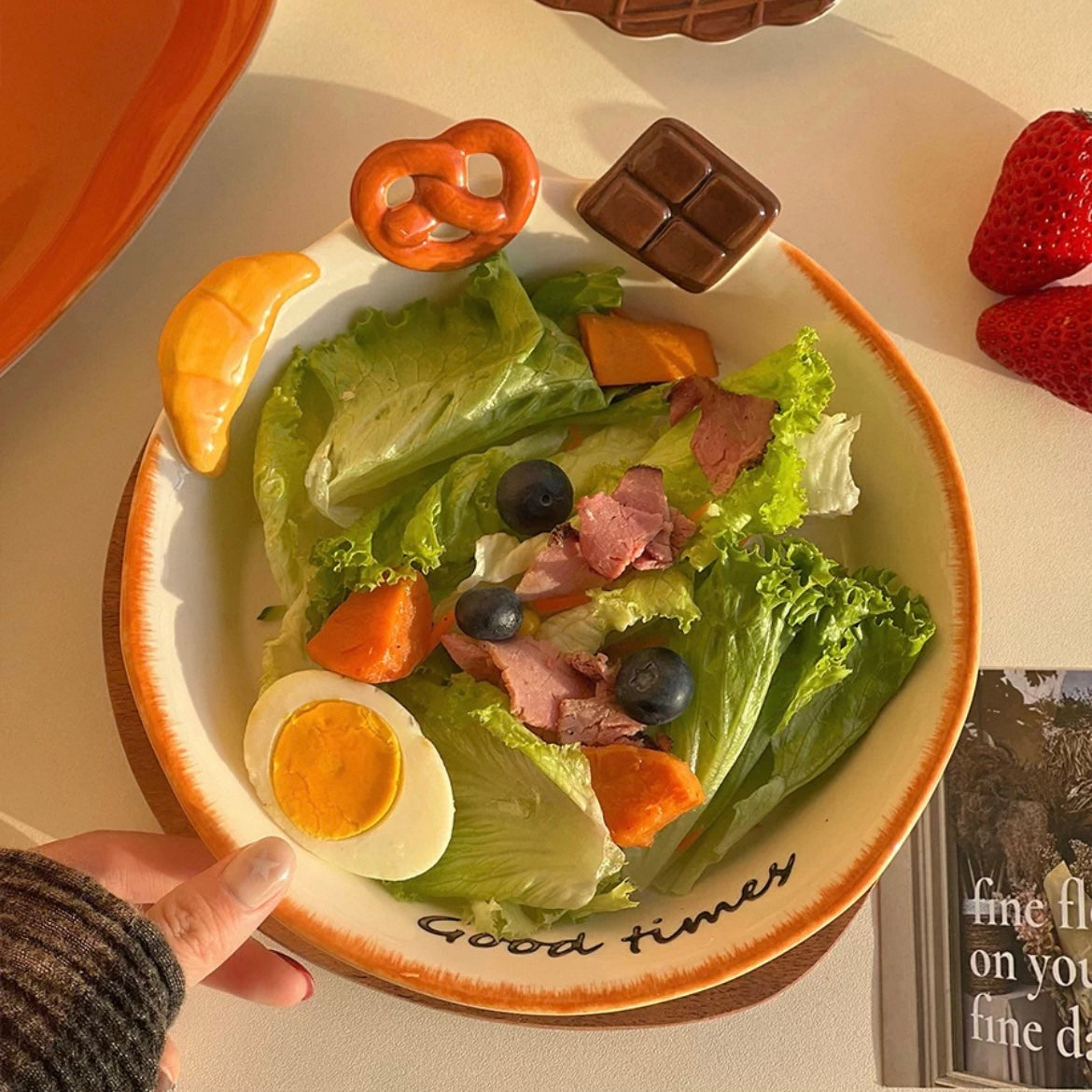 Hand-painted ceramic deep plate with salad showing 3D bread decorations: croissant, pretzel, chocolate, 21CM