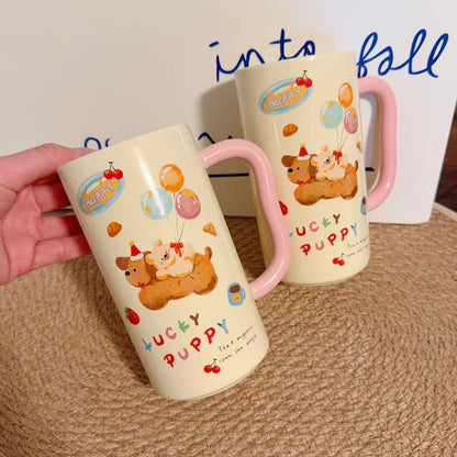 Two ceramic mugs with cartoon designs and text on a textured surface.