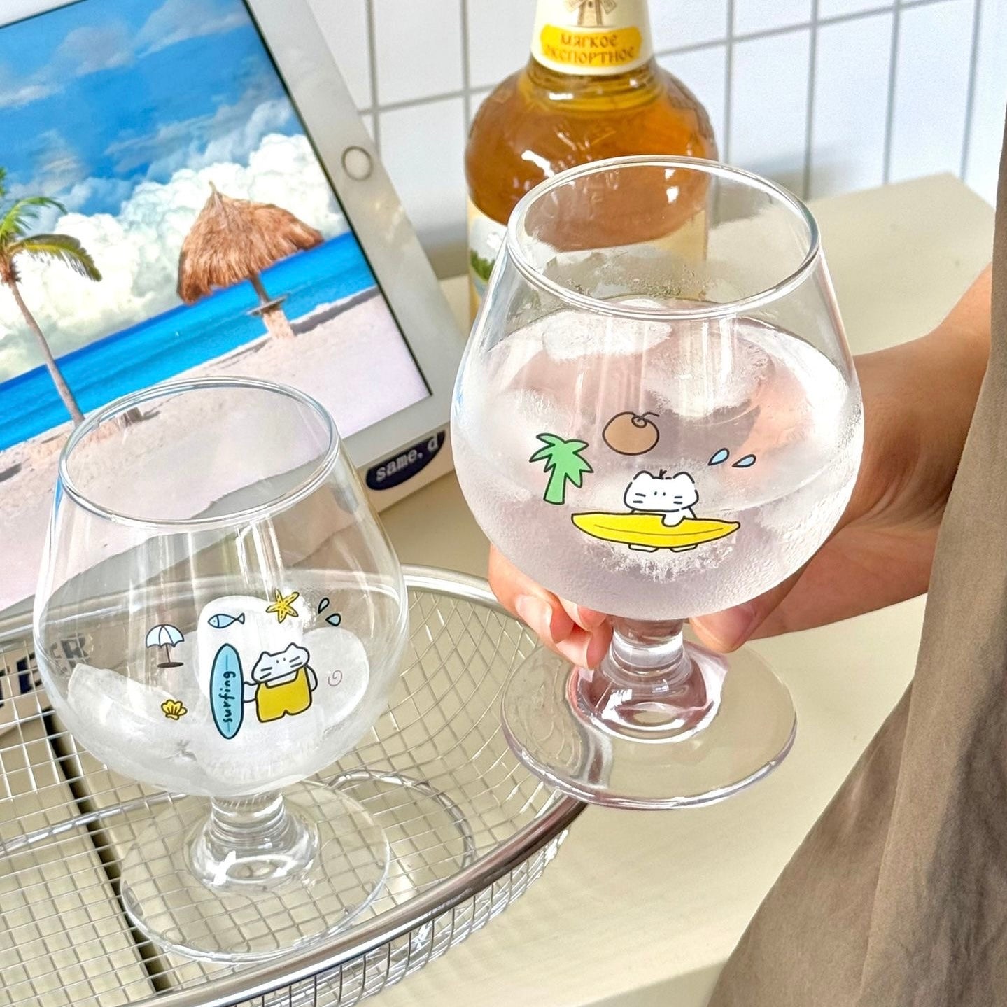 Surfing cat footed glass cups showing blue and yellow surfboard designs, 300ML