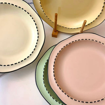 Four macaron color ceramic plates: off-white, yellow, matcha green, pink with manga style black rim