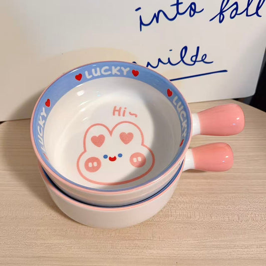 Ceramic bowl with cartoon design and text on a wooden surface