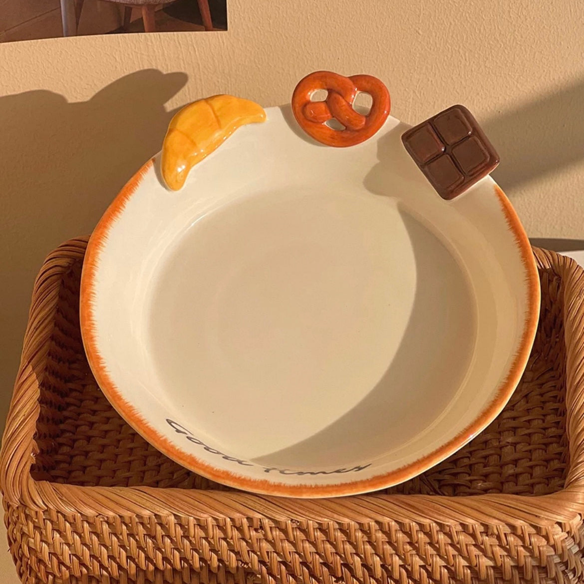 Hand-painted ceramic deep plate with salad showing 3D bread decorations: croissant, pretzel, chocolate, 21CM