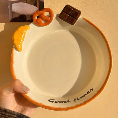 Hand-painted ceramic deep plate with salad showing 3D bread decorations: croissant, pretzel, chocolate, 21CM
