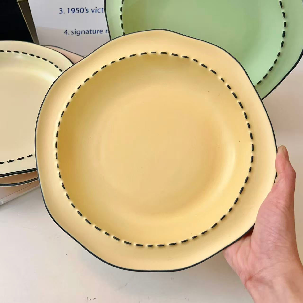 Four macaron color ceramic plates: off-white, yellow, matcha green, pink with manga style black rim