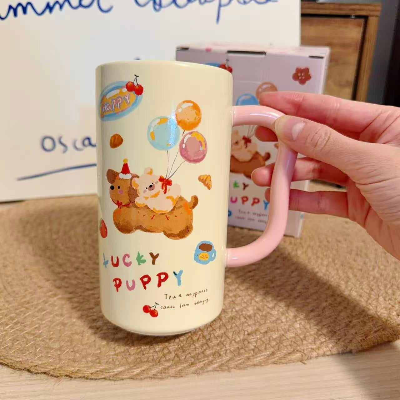 Mug with cartoon designs and text held by a hand on a textured surface