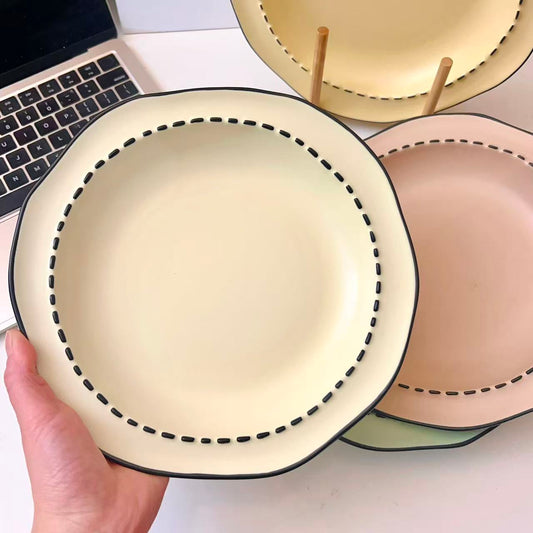 Four macaron color ceramic plates: off-white, yellow, matcha green, pink with manga style black rim