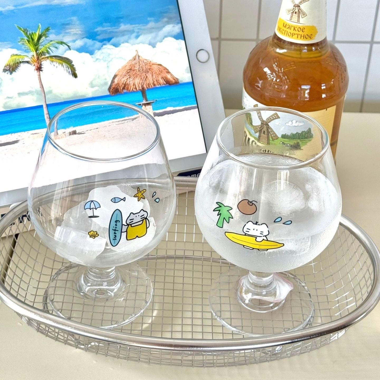 Surfing cat footed glass cups showing blue and yellow surfboard designs, 300ML
